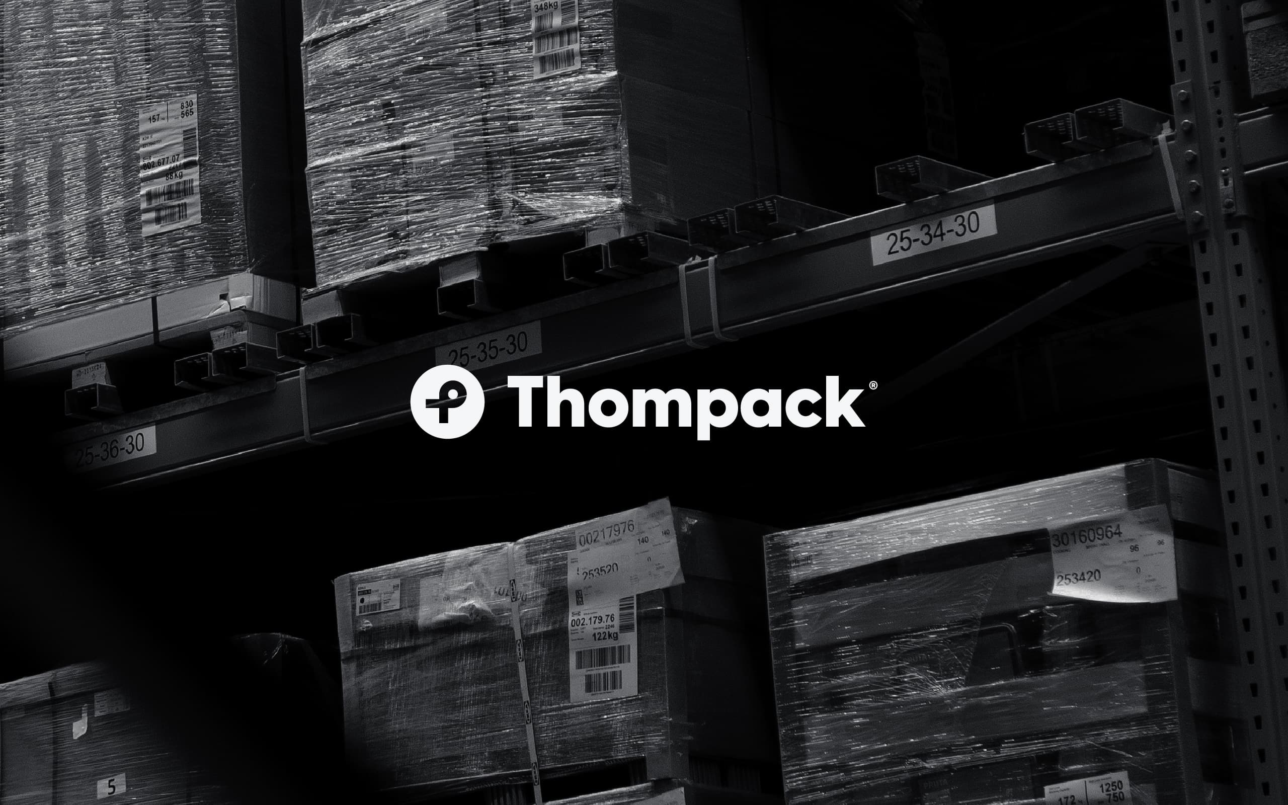 Thompack industrial packaging brand identity presented in a warehouse environment with cargo and logistics materials.