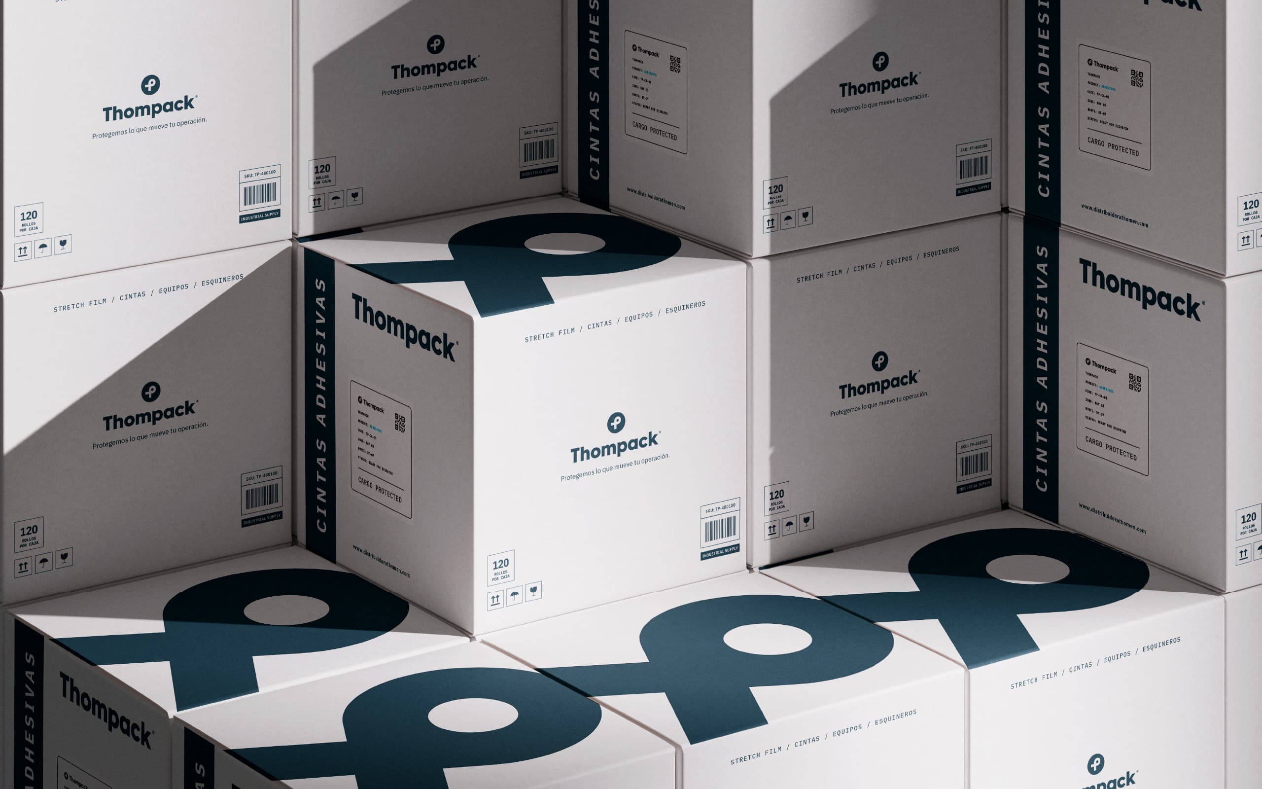 Thompack brand identity applied to industrial packaging boxes and palletized cargo.